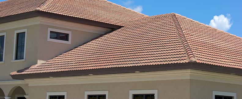 Clay tile roof tops in florida against clear blue sky