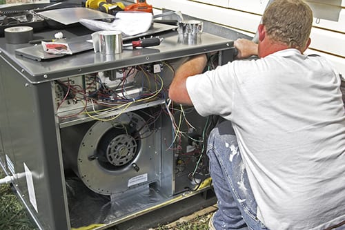  Man installing AC unit