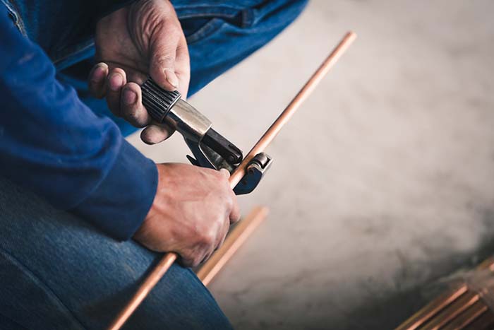 Industry system men worker cut joint with tool of copper