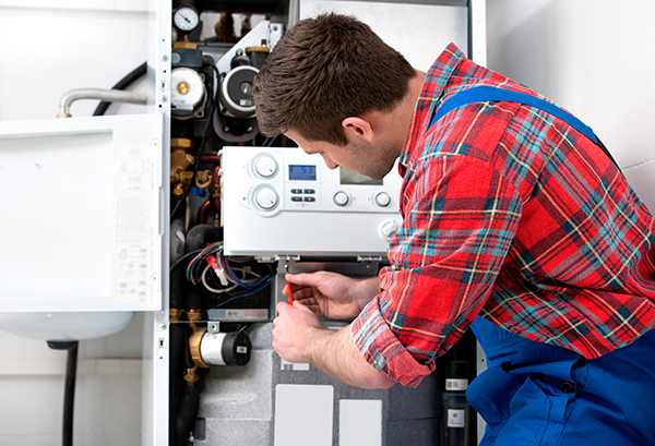 Technician fixing water heater