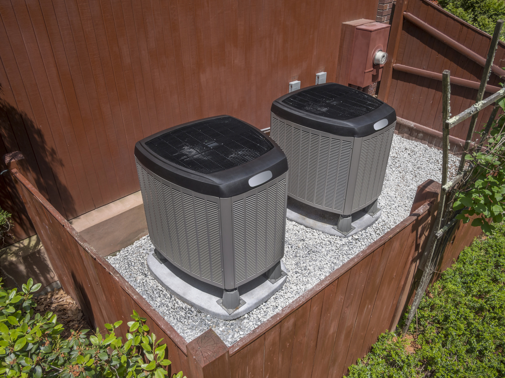 HVAC units outside of a home with a fence enclosing them