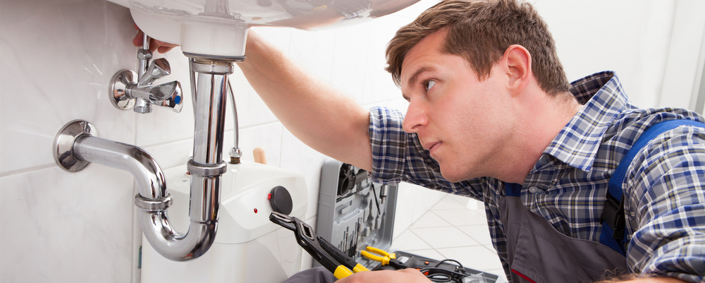 Repairman under sink