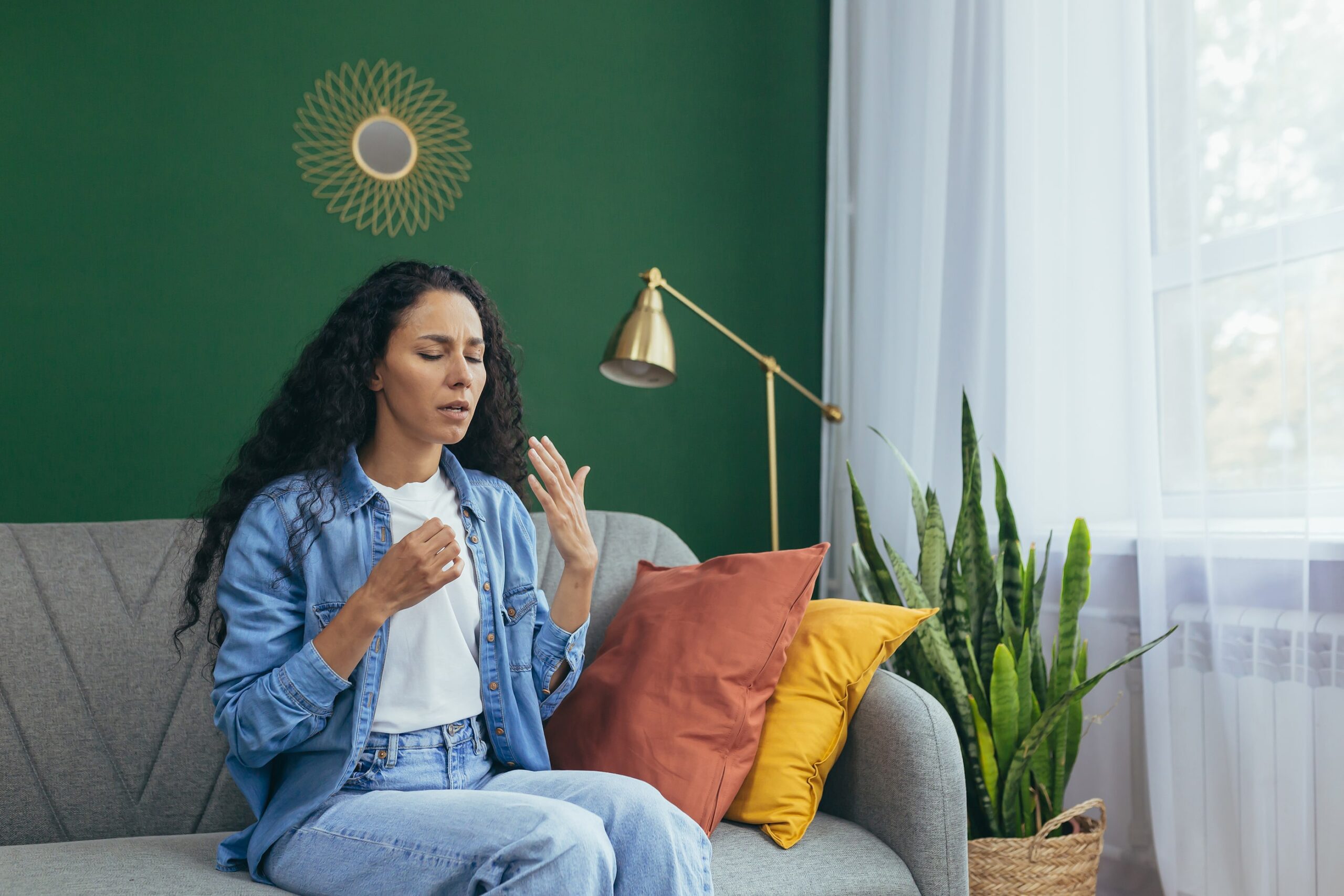 Woman holding in a sneeze